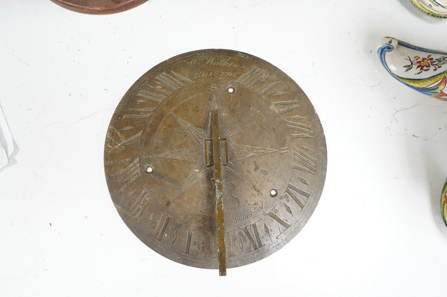 A William IV brass sundial, engraved W. Watkins, Bristol and J Coley, Somerset, 25cm in diameter, the low angle of the gnomon might indicate use in a tropical longitude